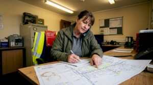 Property manager examining printed drainage map